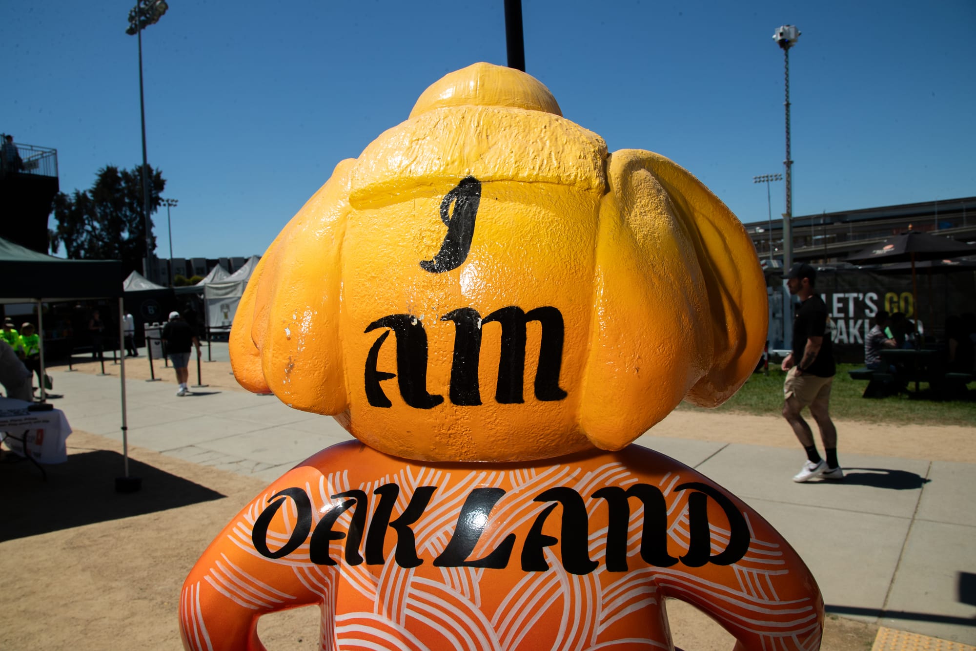Backside of a statue of an anthropomorphic elephant statue. Text painted on it says "I am Oakland."