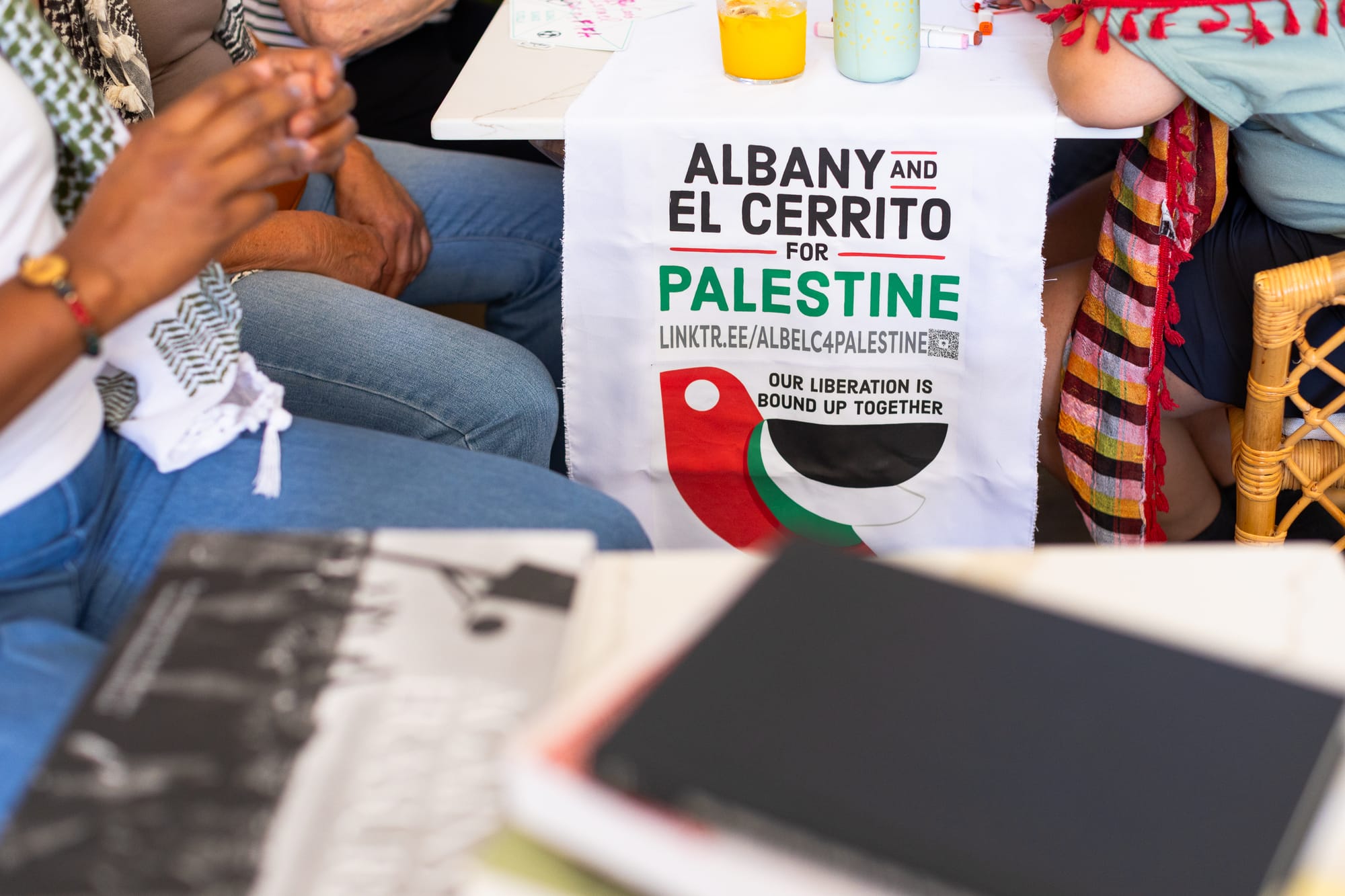 a sign at a cafe reads 'albany and el cerrito for palestine' and 'our liberation is bound up together'