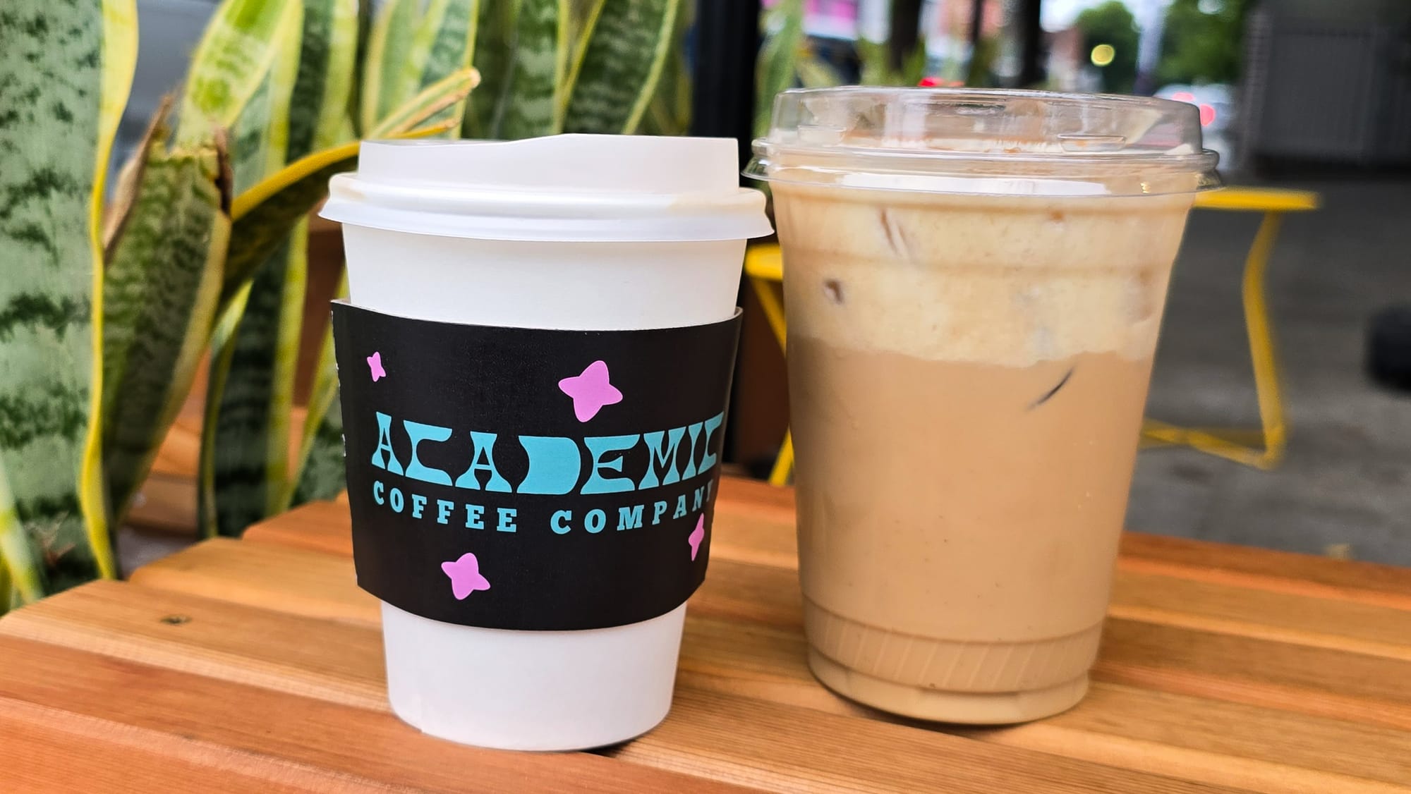 Two to-go coffees on a table.