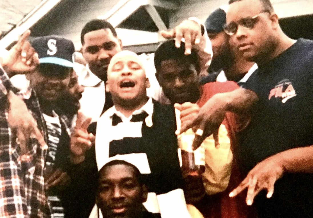 8 men pose for the camera