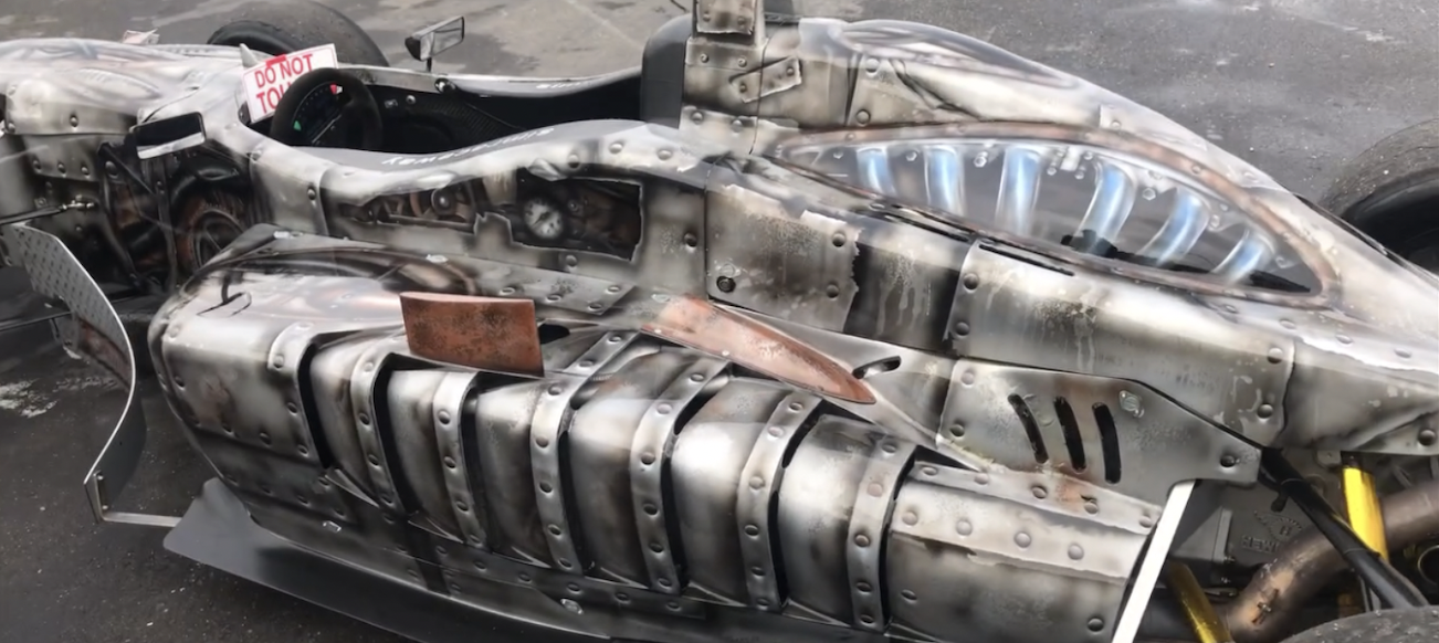 A Formula One racecar airbrushed with mechanical features.