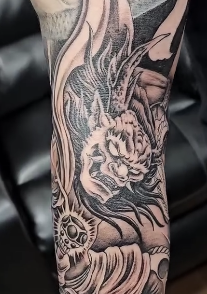 Tattoo on a limb depicting a demon