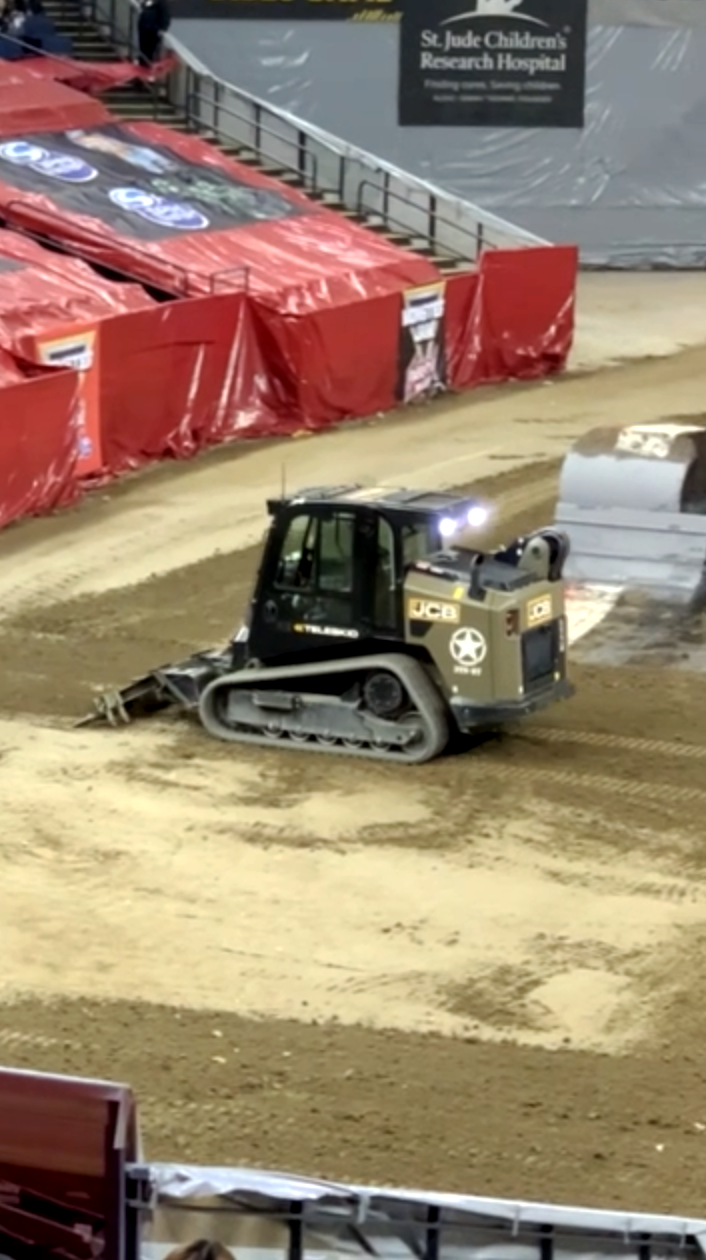 A machine smooths the track.