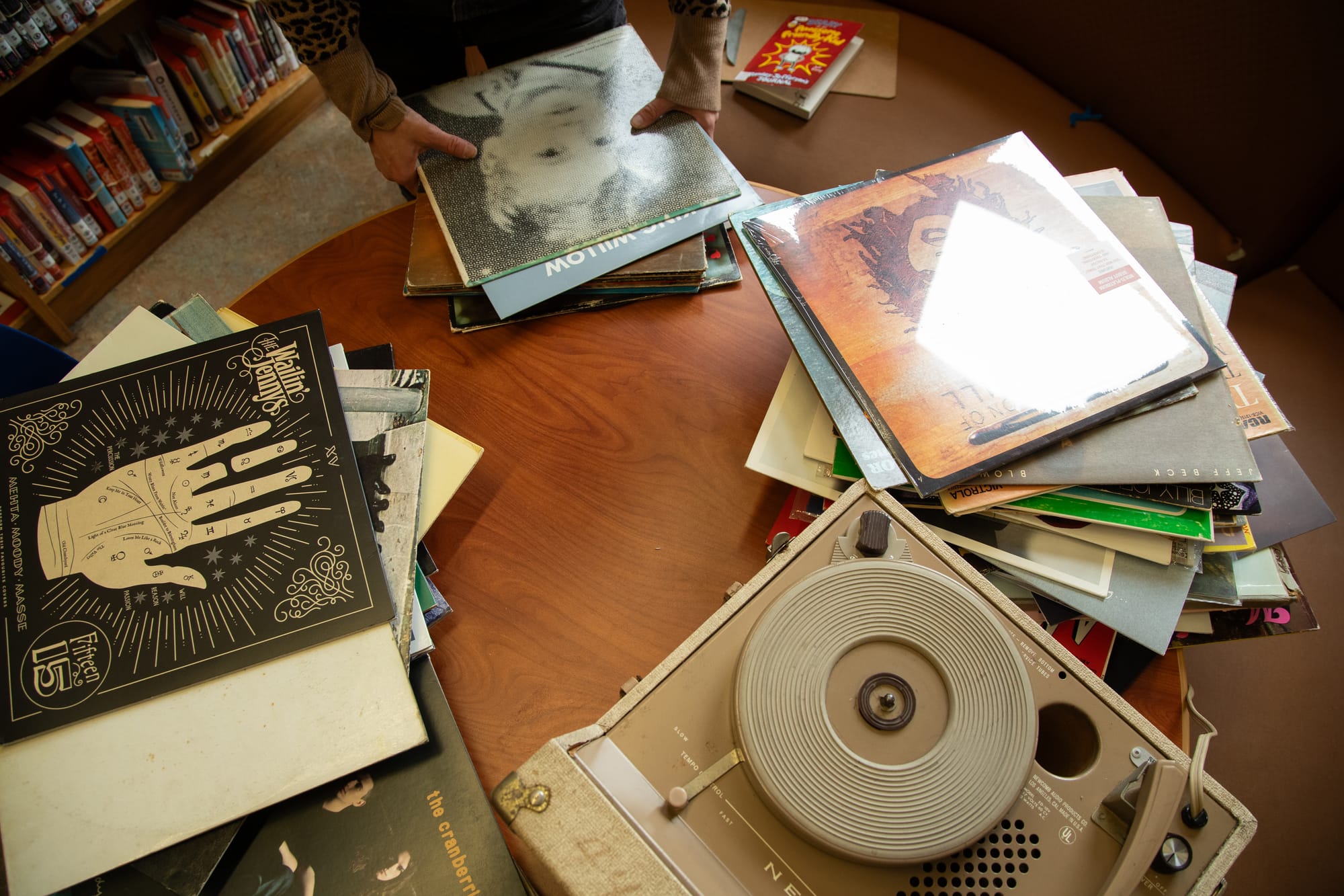 a vintage record player and vinyl records on a table