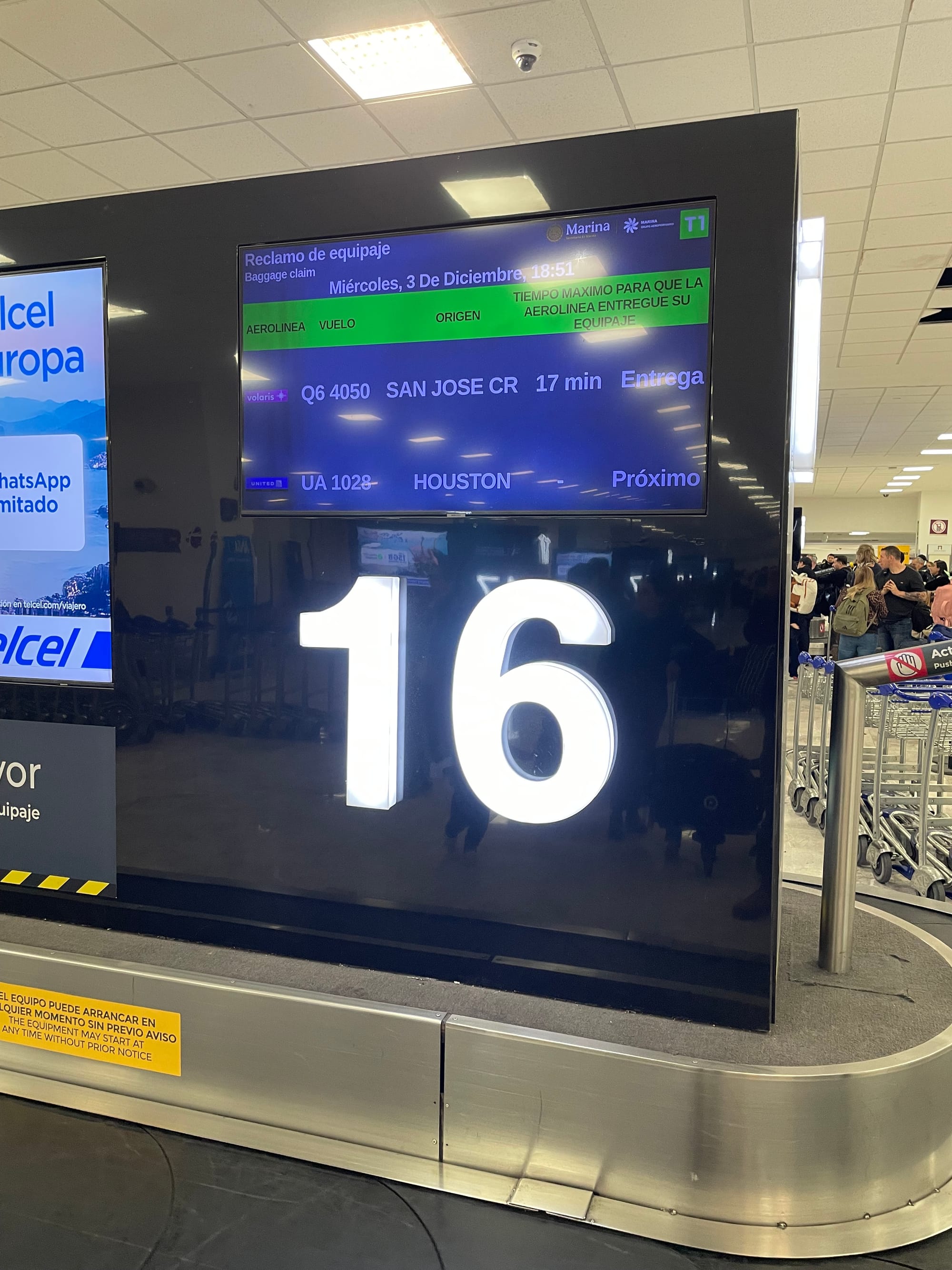 a sign in an airport that reads 'number 16' and shows that the photographer just landed in Costa Rica