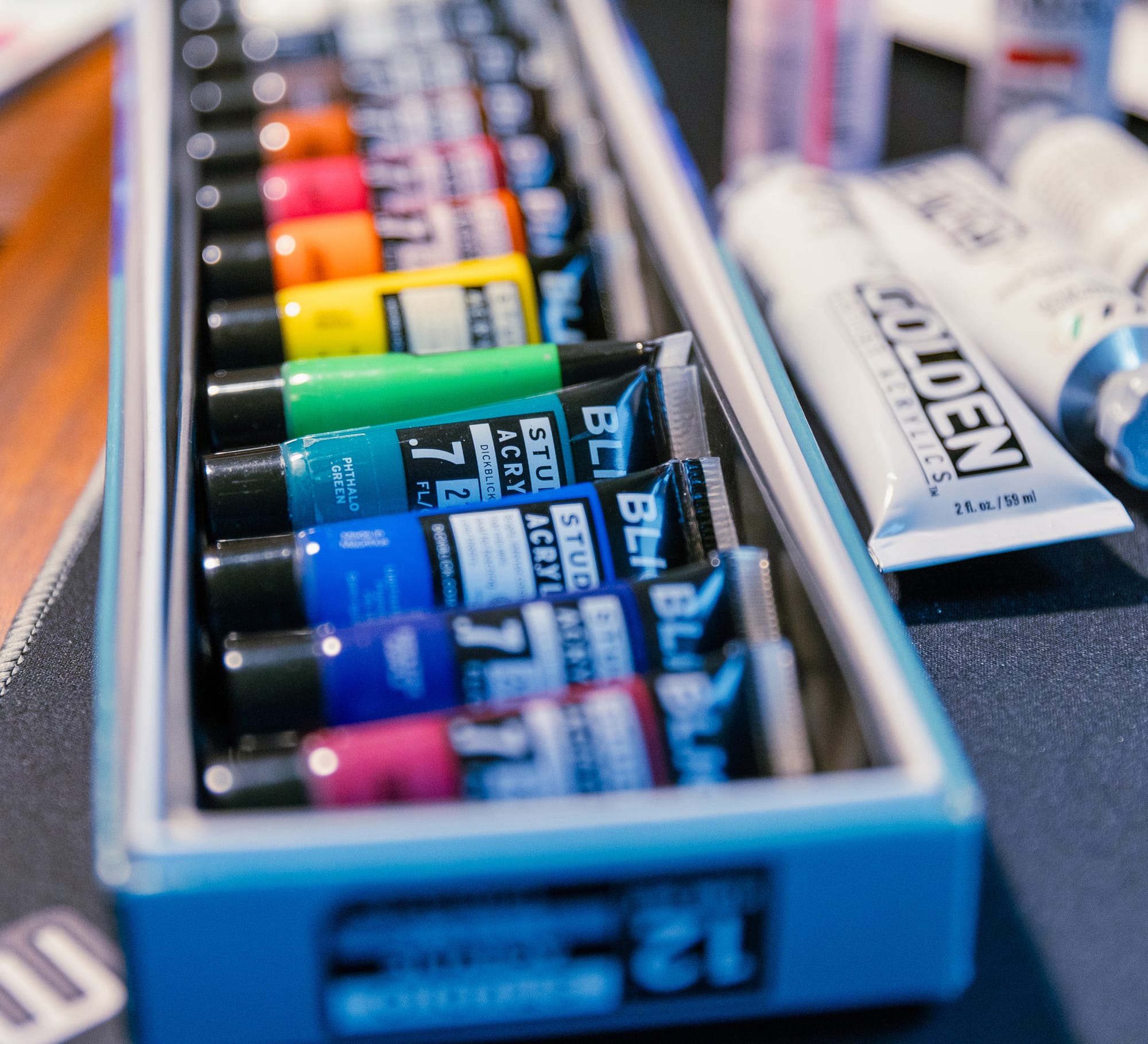 A closeup of a row of paint tubes.