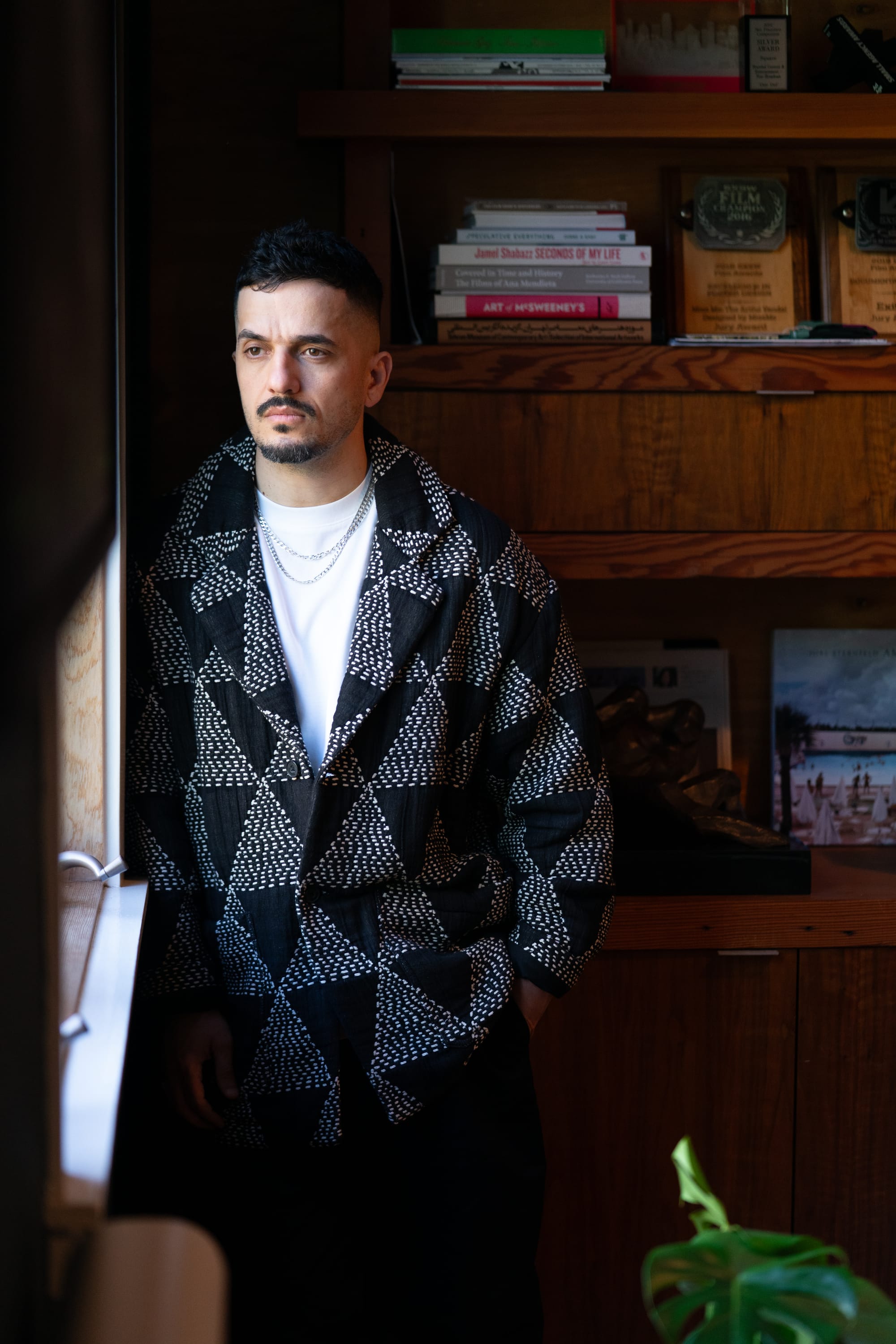Man in a black and white sweater looking pensive.