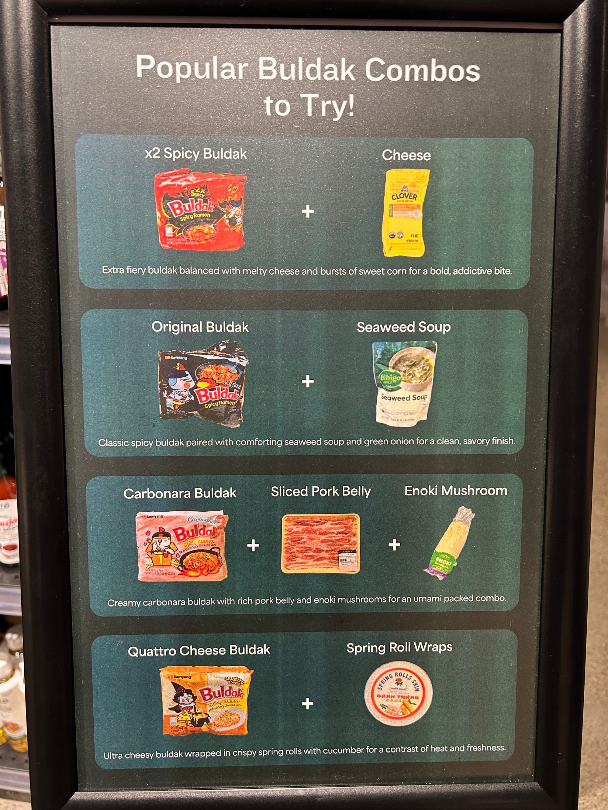A sign reads, "Popular Buldak combos to try! Original Buldak + Seaweed Soup, classic spicy buldak paired with comforting seaweed soup and green onion for a clean, savory finish. Carbonara buldak + sliced pork belly + enoki mushroom, creamy carbonara buldak with rich pork belly and enoki mushrooms for an umami packed combo. Quattro cheese buldak + spring roll wraps, ultra cheesy buldak wrapped in crispy spring rolls with cucumber for a contrast of heat and freshness.