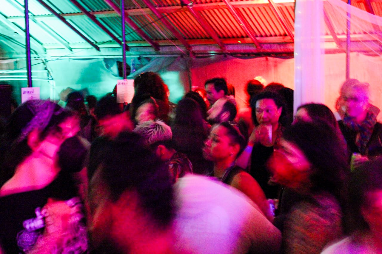 People dance in a blurry mass.