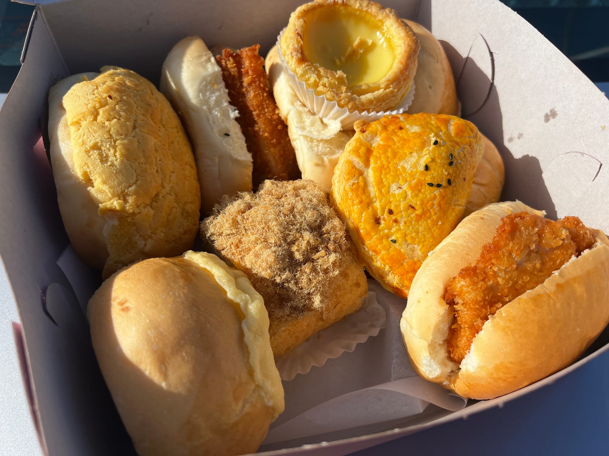 A box of Chinese bakery goods, including cocktail bun, hot dog bun, chicken sandwich, and pork floss bun