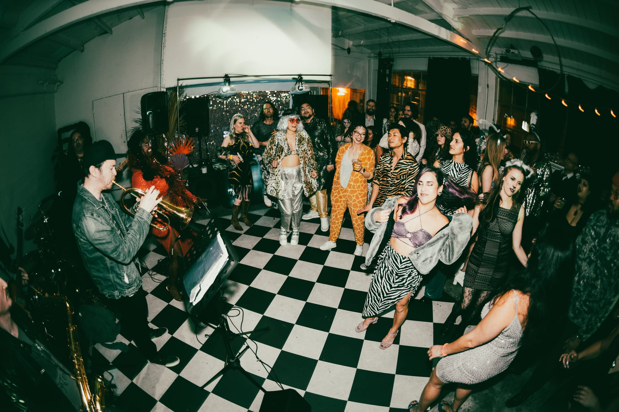 a party in a space with a black and white checkered floor and live music