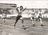 A black and white photograph of a Japanese woman crossing the finish line at the 1928 Olympics.